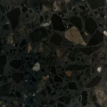 Close-up of TE023’s dark, polished stone surface featuring irregular black, brown, and white mineral fragments throughout.